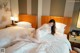 A woman laying on a bed in a hotel room.