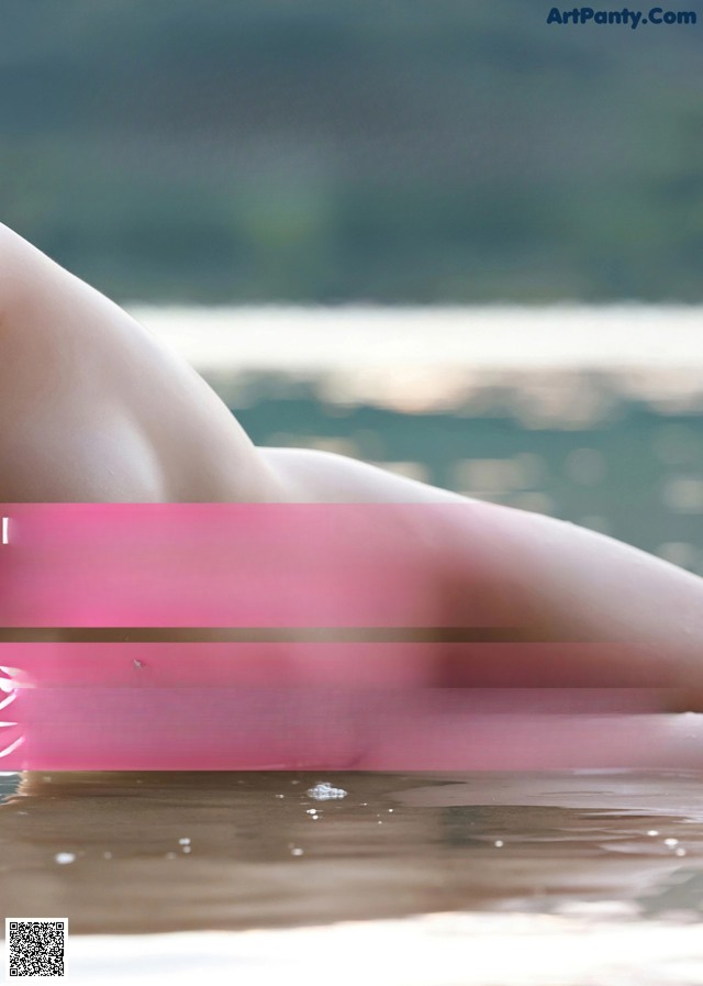 A poster for a japanese movie with a picture of a naked woman in the water.