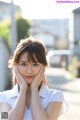 A young woman with her hands on her face.