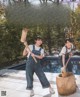 A couple of women standing next to each other near a pool.