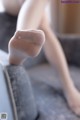 A close up of a woman's legs in white stockings.