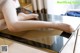 A woman sitting on top of a glass table.