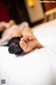 A woman laying on top of a bed with her feet up.