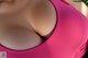 A close up of a woman's breasts in a pink bikini.